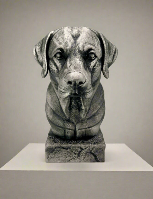 A 3D printed bust of a Labrador dog in a metallic silver and black look. Prominently displayed on a white surface.