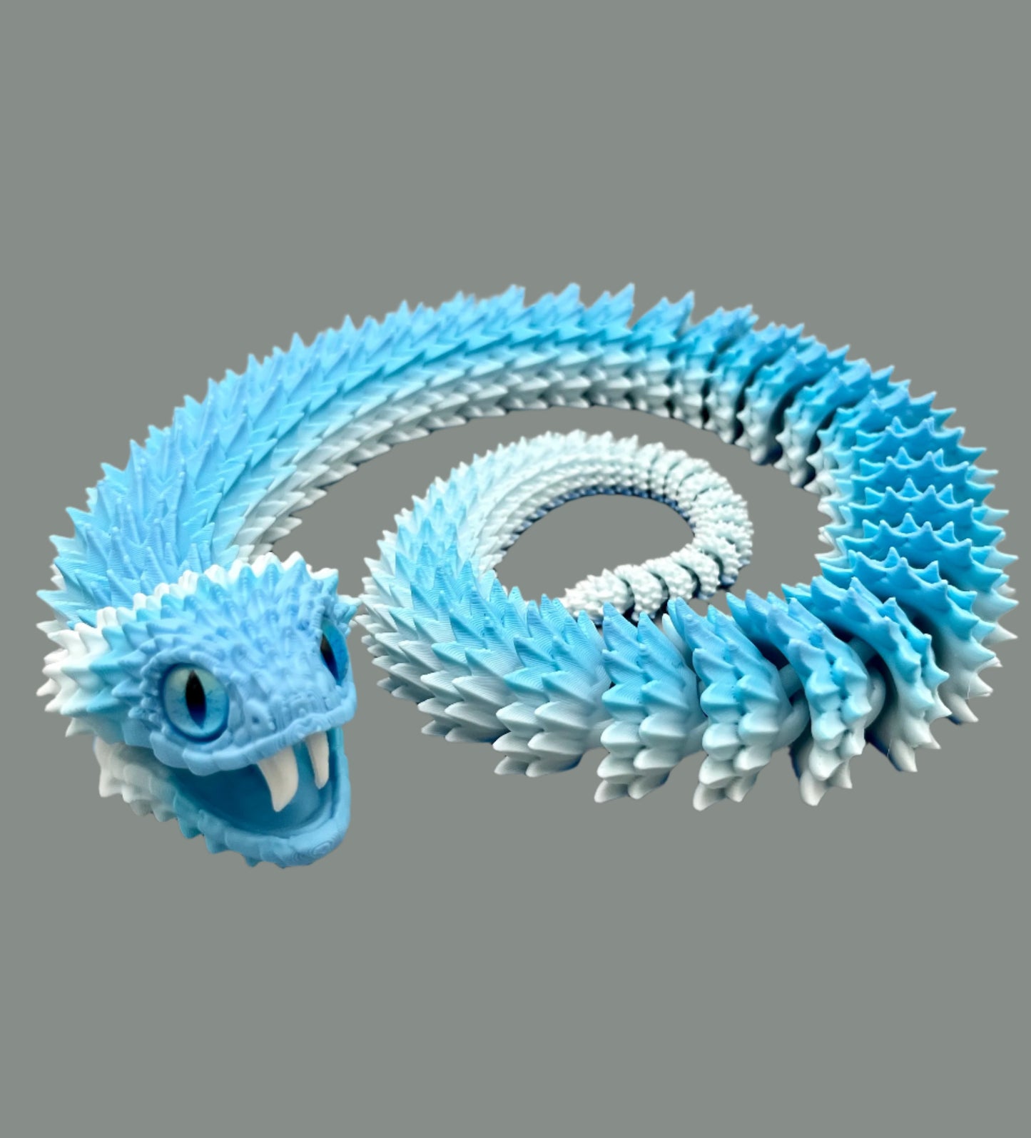 A 3D printed ice blue gradient coloured Bush Viper snake, set in a coiled position, with opened mouth and exposed teeth, realistic features and detailed scales all over. Set on a light grey background.