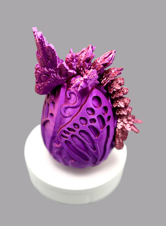 Beautiful 3D printed dragon egg with matching dragon perched on top, displaying textured heart and feather features all over it's head, body and tail