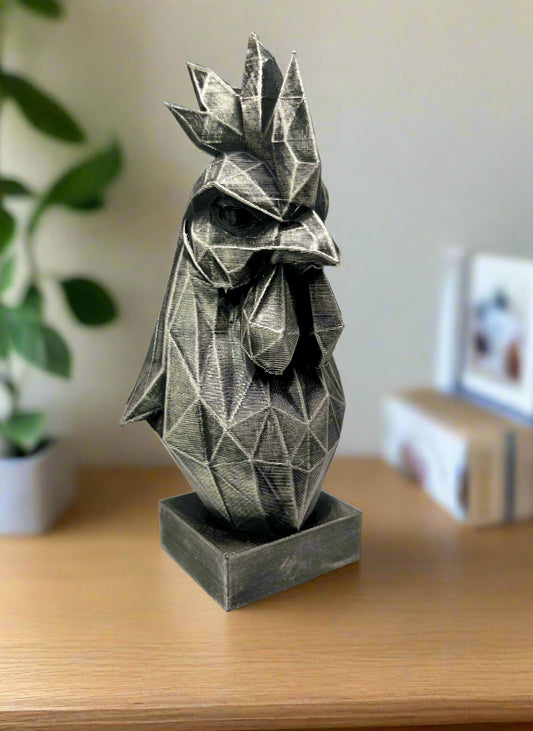 A 3D printed geometric style black cockerel bust printed in black and silver finish, displayed on a wooden table