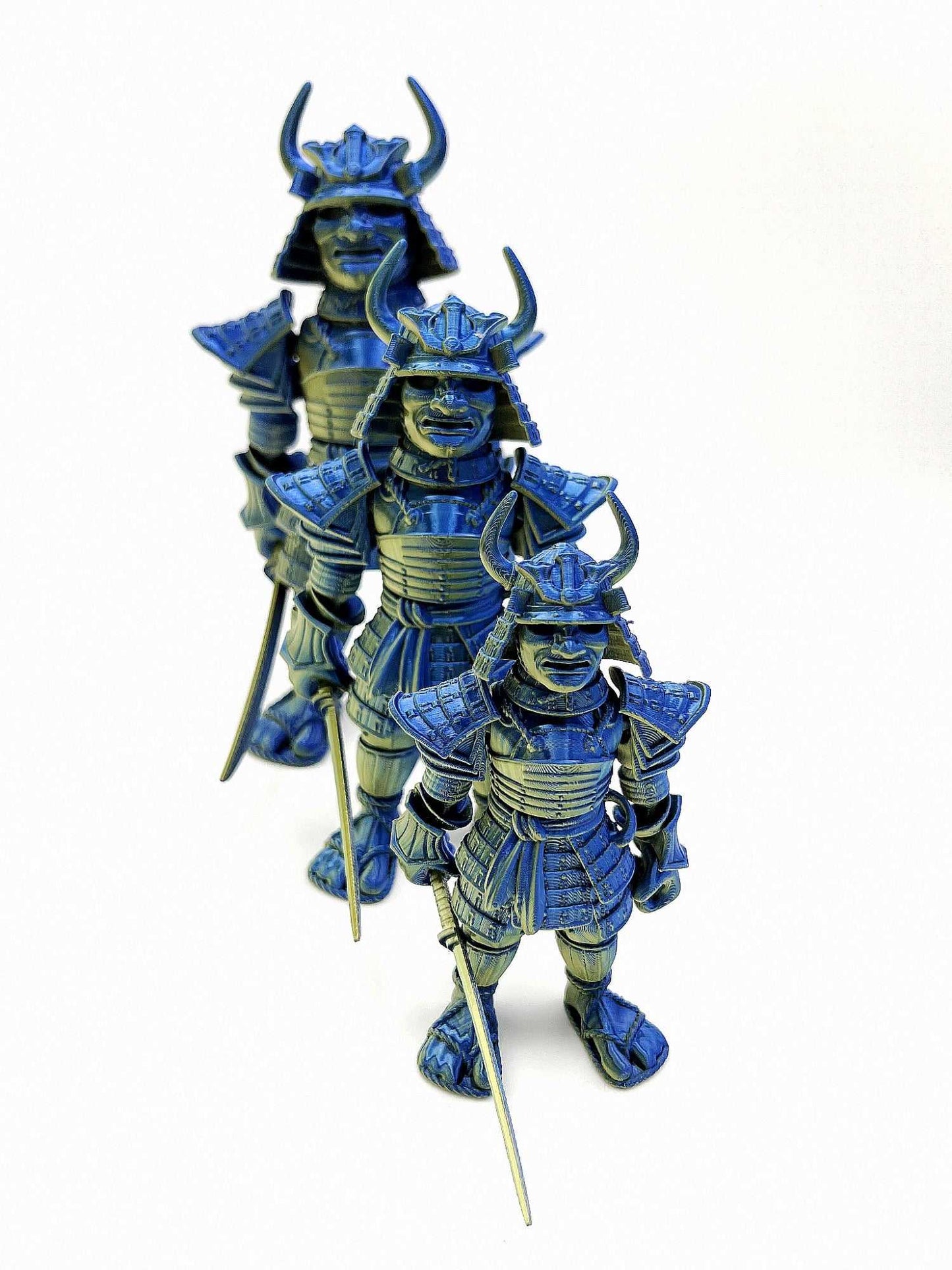 A set of 3 Samurai Warriors (small, medium and large), all 3D printed and wearing traditional Japanese armour and holding a detachable katana sword. Blue and gold in colouring.