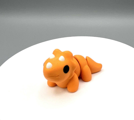 Side view of an eco-friendly 3D Printed Triceratops Mini figure with its signature three horns, articulated body and textured frill. Perfectly pocket sized.