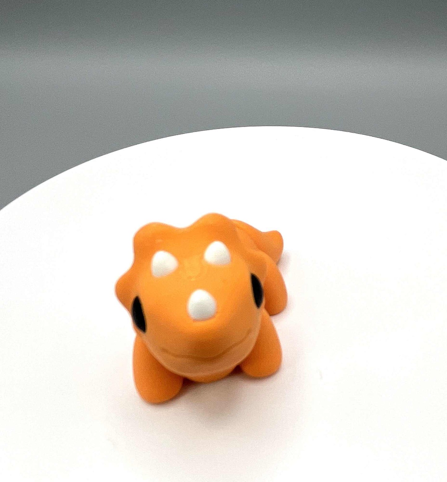 Front view of an eco-friendly 3D Printed Triceratops Mini figure with its signature three horns, articulated body and textured frill. Perfectly pocket sized.