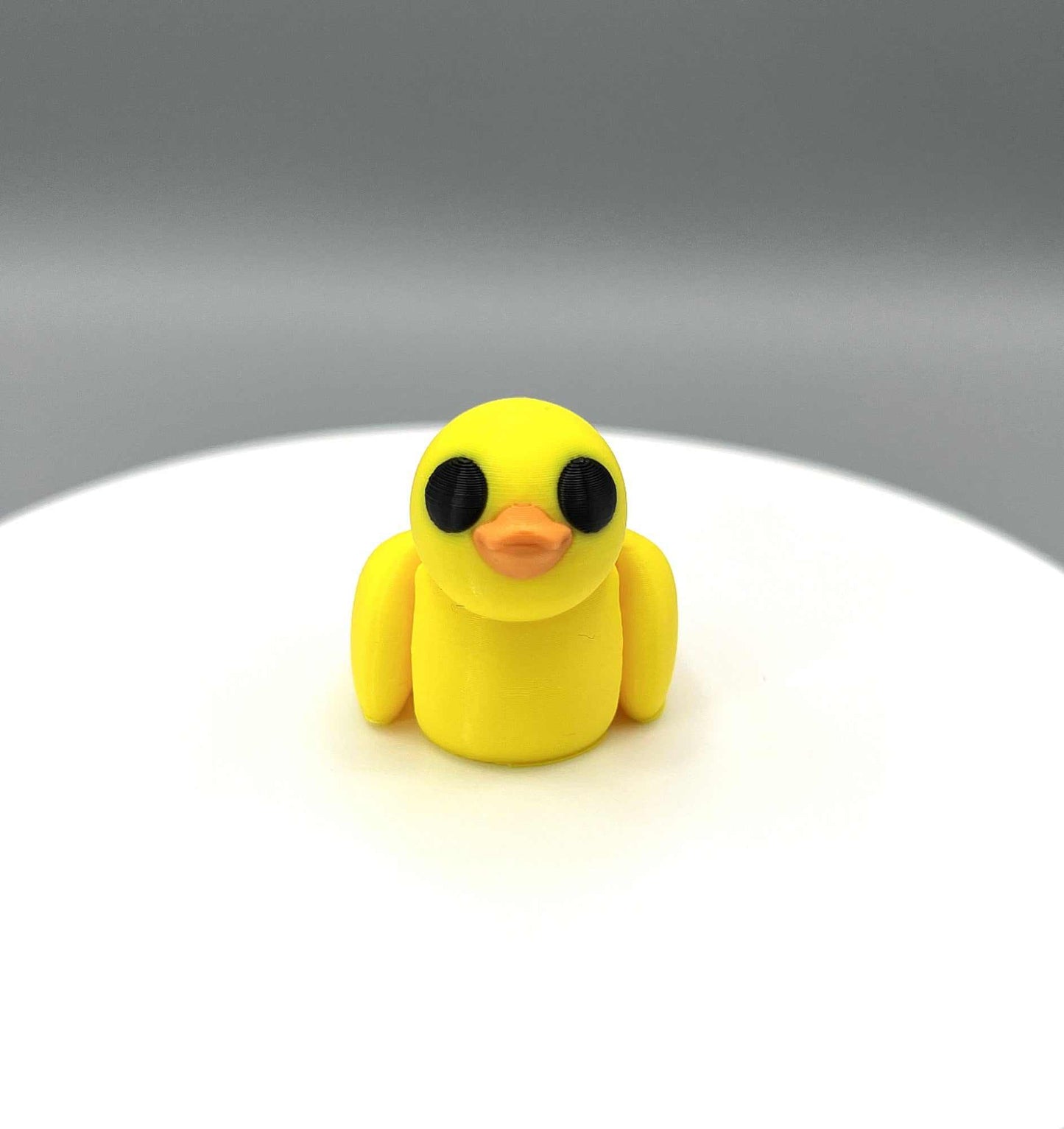 An eco-friendly 3D printed duck mini figure, with moveable wings and big eyes. Perfectly pocket sized.