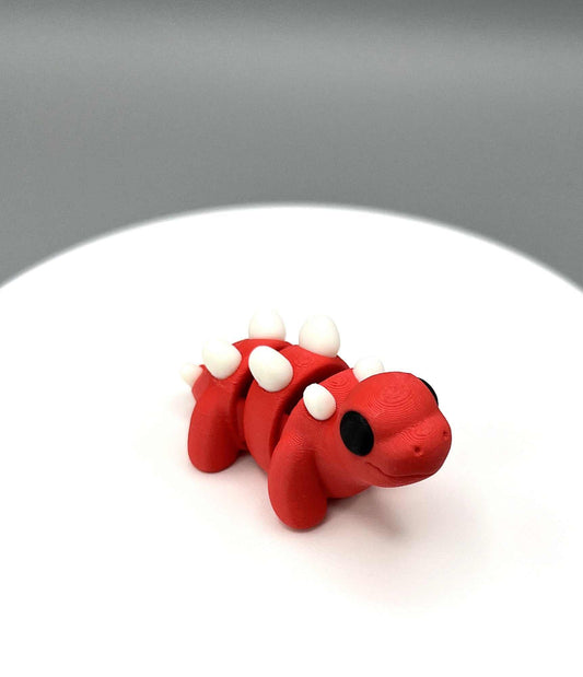 An eco-friendly 3D Printed Stegosaurus Mini Figure with little horns on its back and a cute face. Perfectly pocket sized.