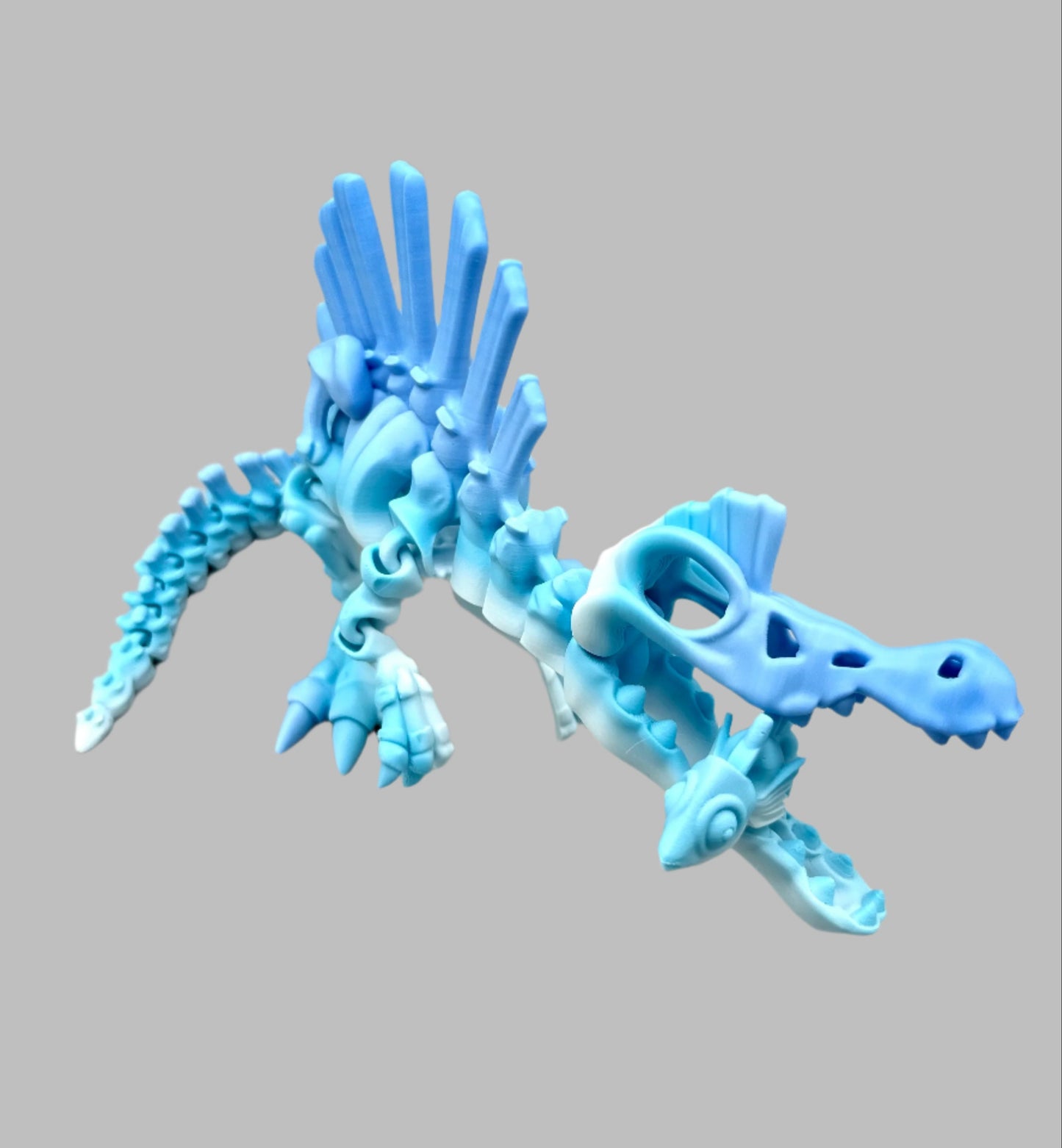 3D printed Spinosaurus skeleton dinosaur with highly detailed face and body, holding a fish in its open jaws