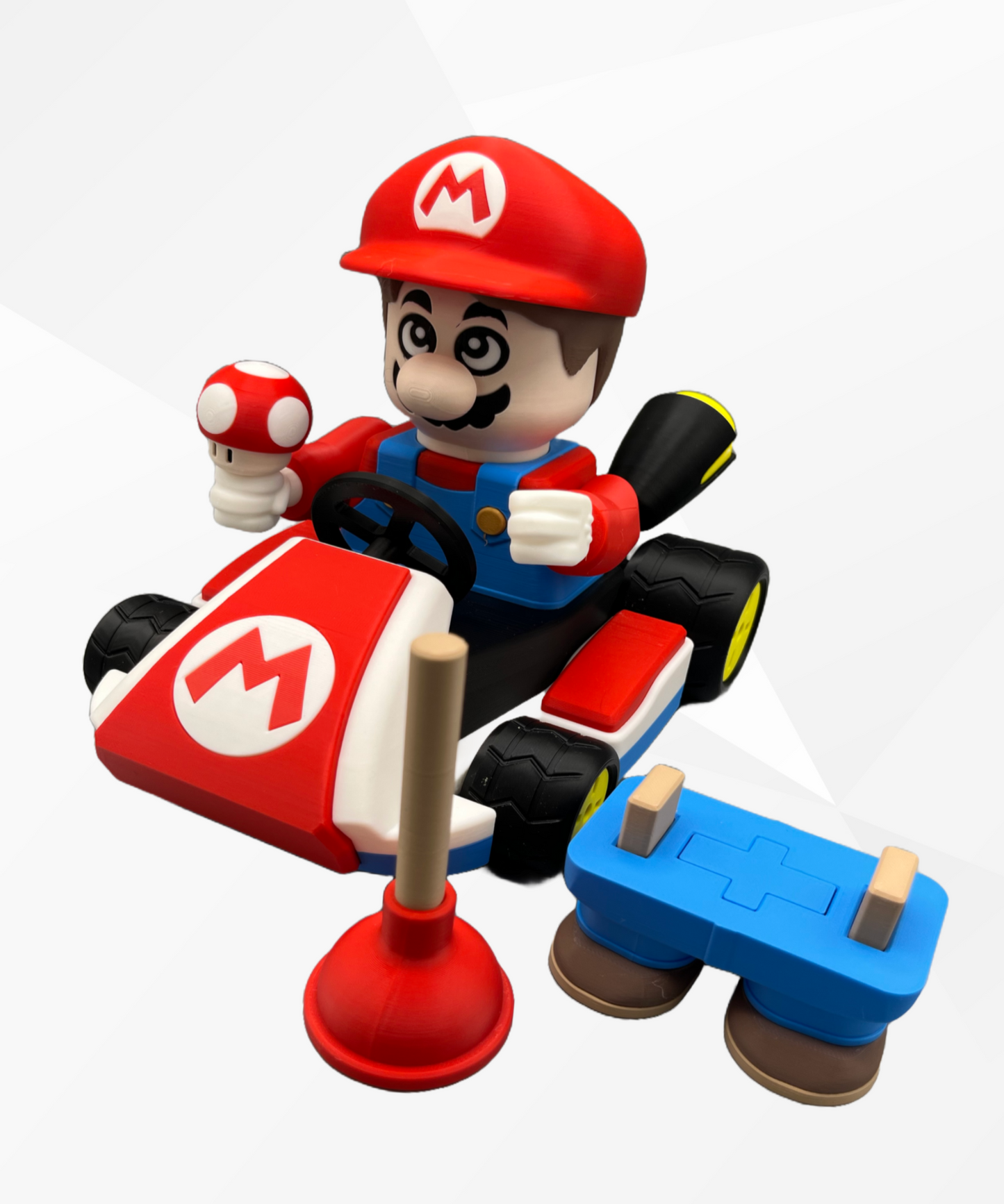 3D printed character in a red hat and blue overalls, with a moustache. Sat in a racing kart with a mushroom in his hand and a plunger next to him. Set on a white background.