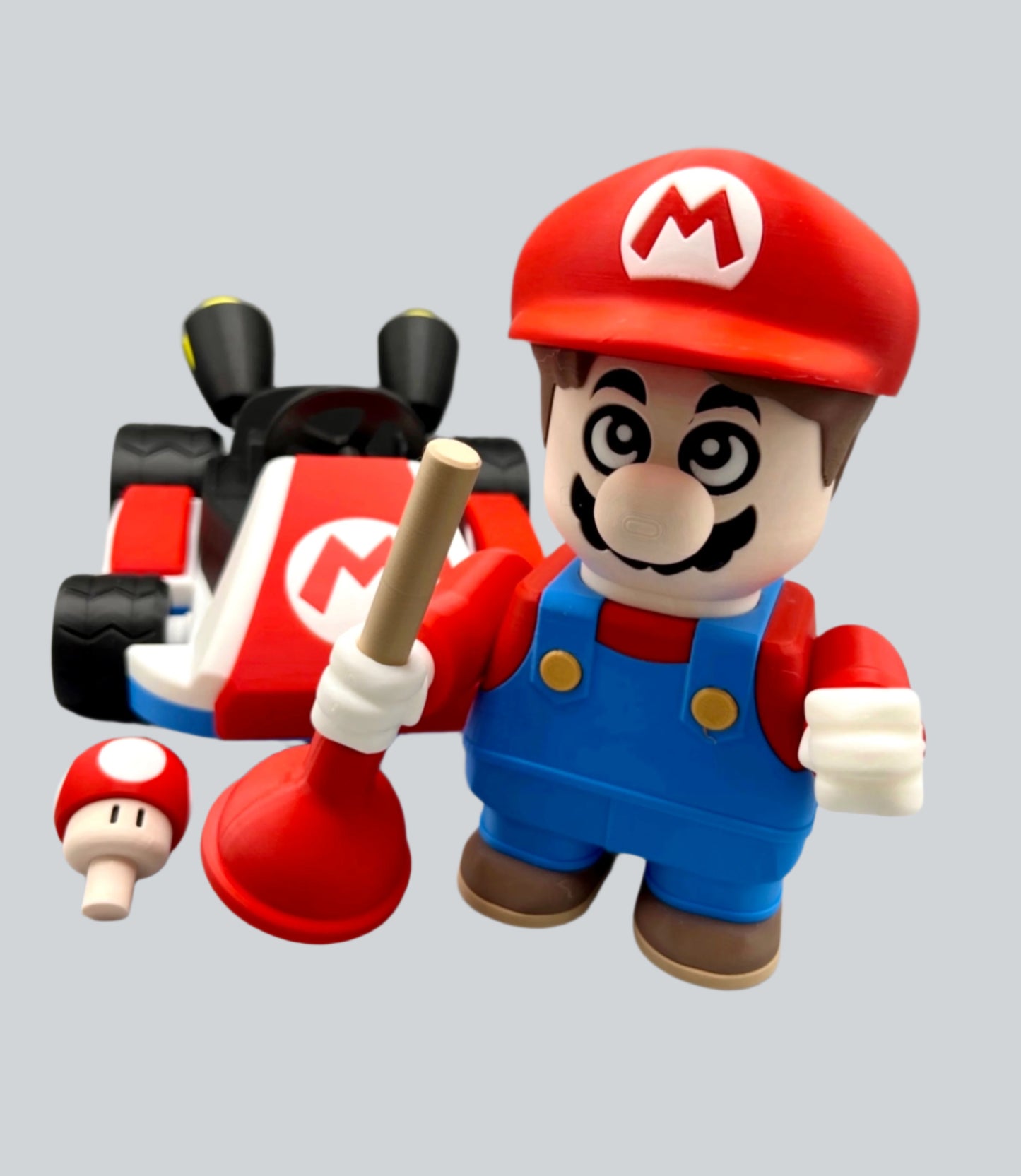 3D printed character in a red hat and blue overalls, with a moustache. Standing in front of his racing kart with a plunger in his hand and a mushroom next to him. Set on a light grey background.