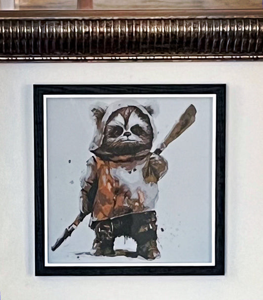 A 3D printed textured picture of an Ewok in a black frame and hung on a wall