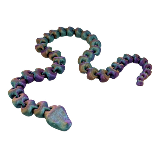 An articulated 3D-printed snake, in a shimmery finish and featuring realistic facial features.