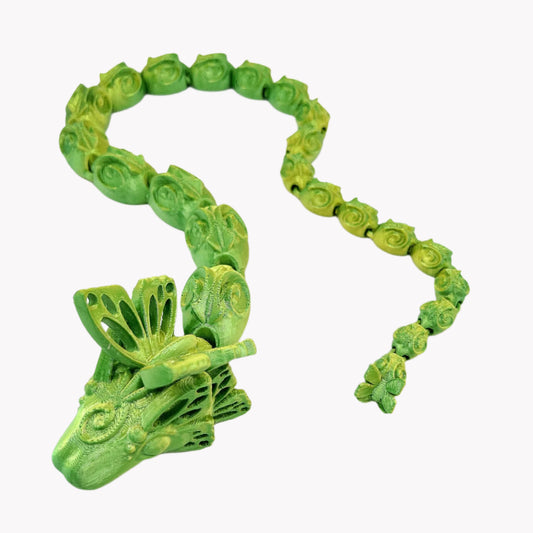 A beautiful 3D printed snake with a decoratively patterned, articulated body featuring butterfly detailing on it's head and tail.