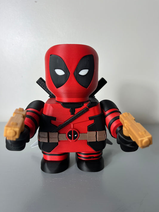3D printed superhero in red and black suit with mask, holding 2 guns and having 2 katana swords attached to his back