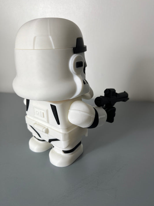 Back view of 3D printed film character in a white suit with white mask, holding a gun