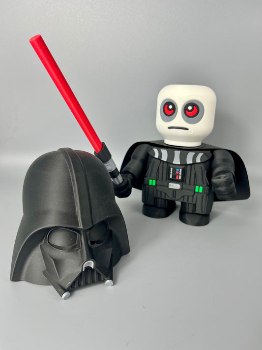 3D printed figure of a character in a black costume, black mask on the floor and face exposed featuring red eyes. Holding a red lightsaber and standing against a grey background