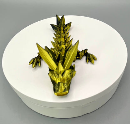 A 3D-printed small sized dragon with crystals on its head, body and tail. Positioned on a white circular base.