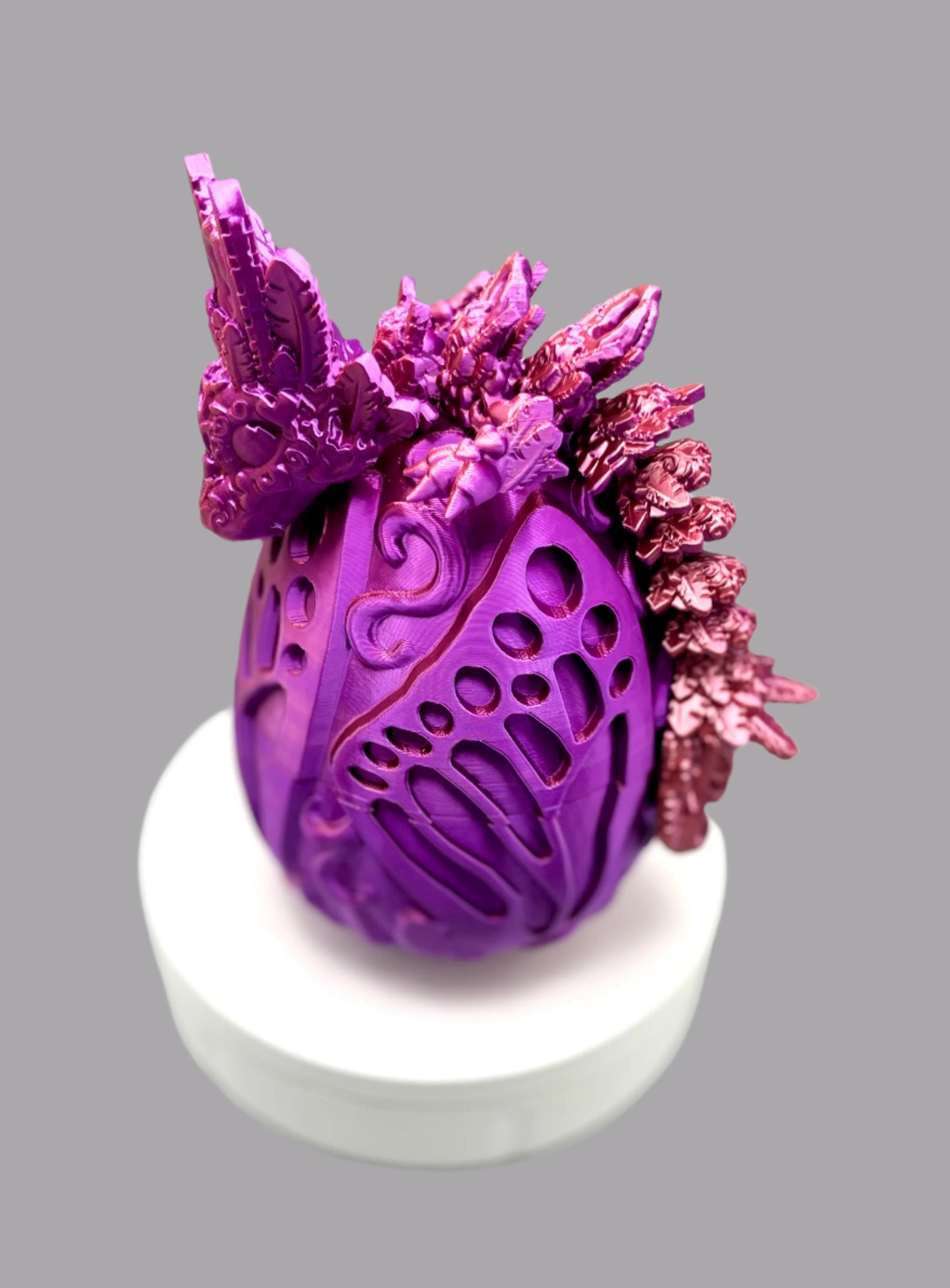 Beautiful 3D printed dragon egg with matching dragon perched on top, displaying textured heart and feather features all over it's head, body and tail