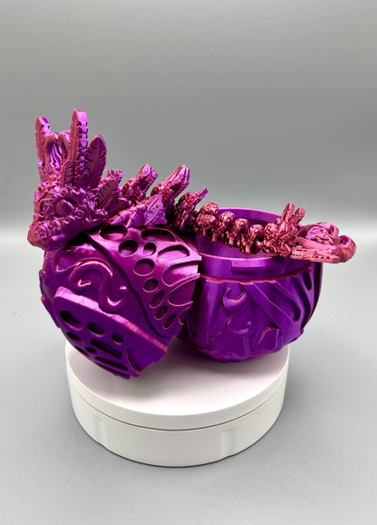 Opened 3D printed dragon egg with matching dragon laying majestically across it, displaying beautiful textured heart and feather features all over, from head to tail