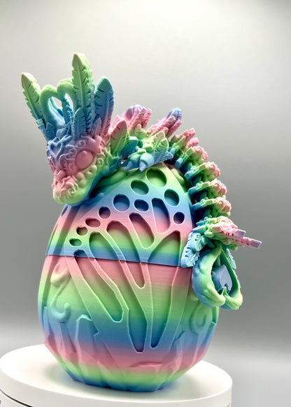 Beautiful 3D printed rainbow dragon egg with matching dragon perched on top, displaying textured heart and feather features all over it's head, body and tail
