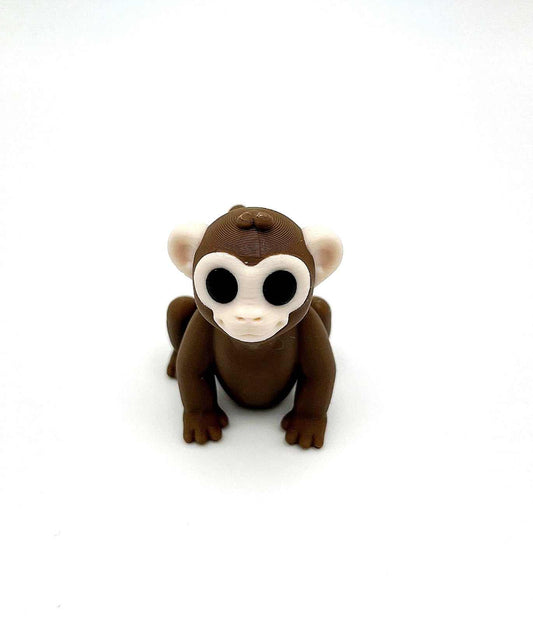 A monkey mini figure with a cheeky playful face in a sitting position and looking for fun. Perfectly pocket sized.