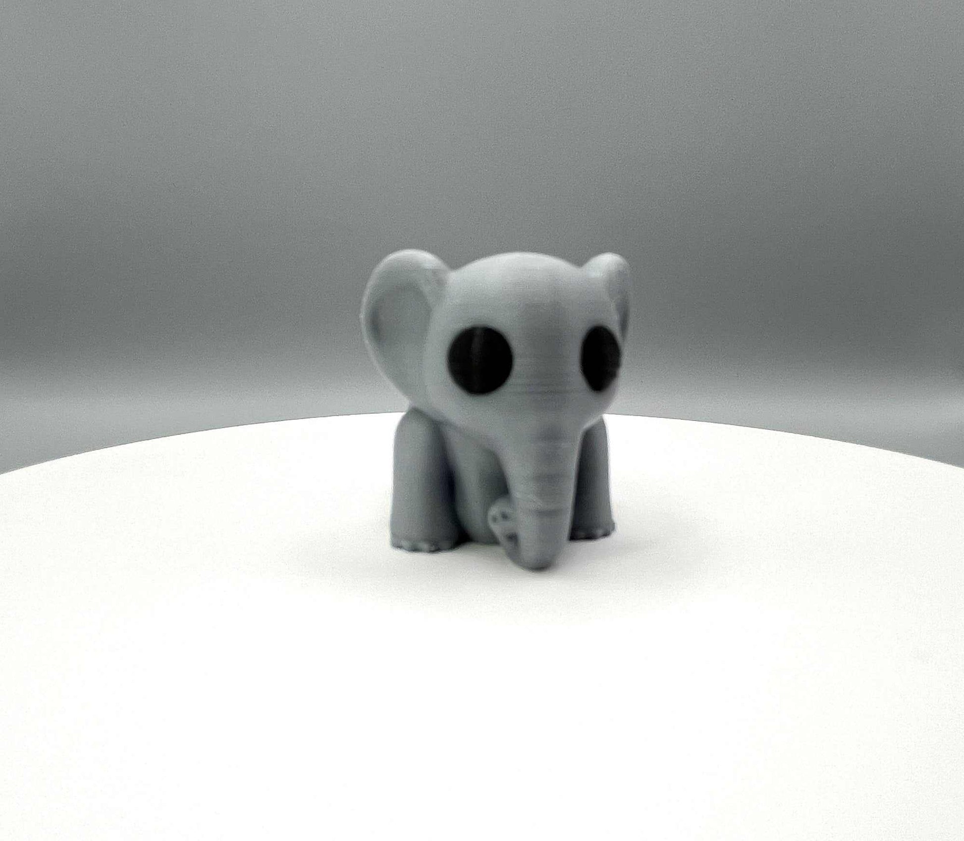 A cute 3D printed elephant mini figure featuring big floppy ears, a curled trunk and an articulated body. Perfectly pocket sized!