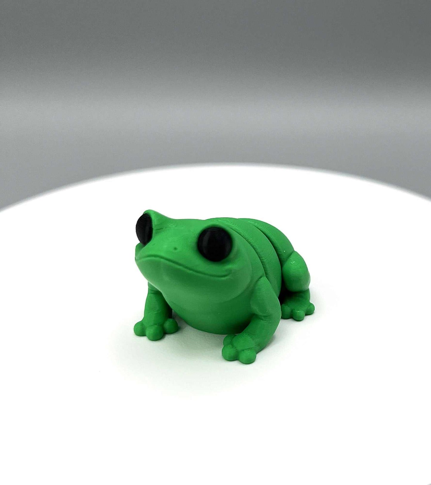 A 3D Printed Bullfrog Mini Figure with big eyes and a cute face looking ready to jump! 