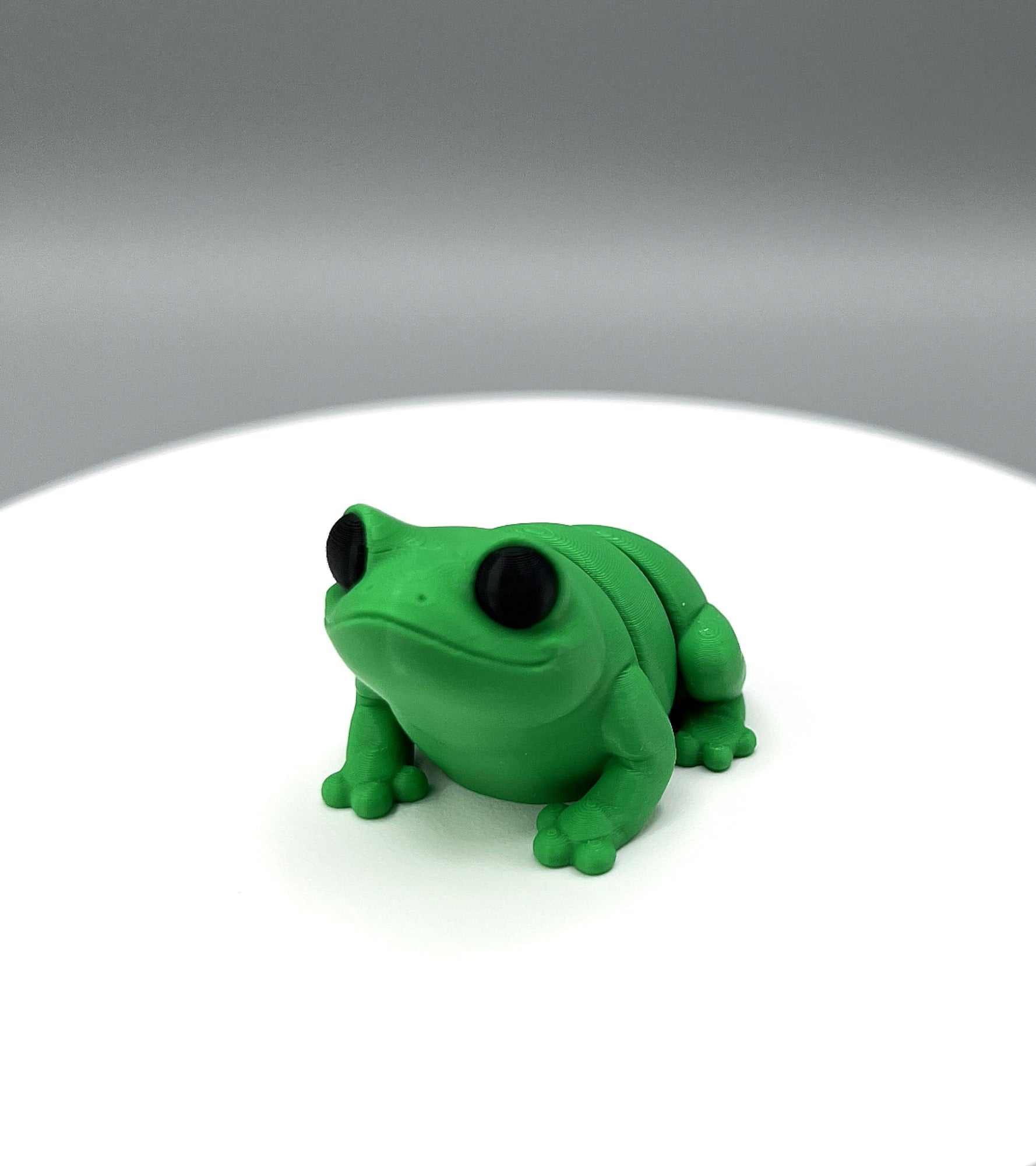 A 3D Printed Bullfrog Mini Figure with big eyes and a cute face looking ready to jump! 