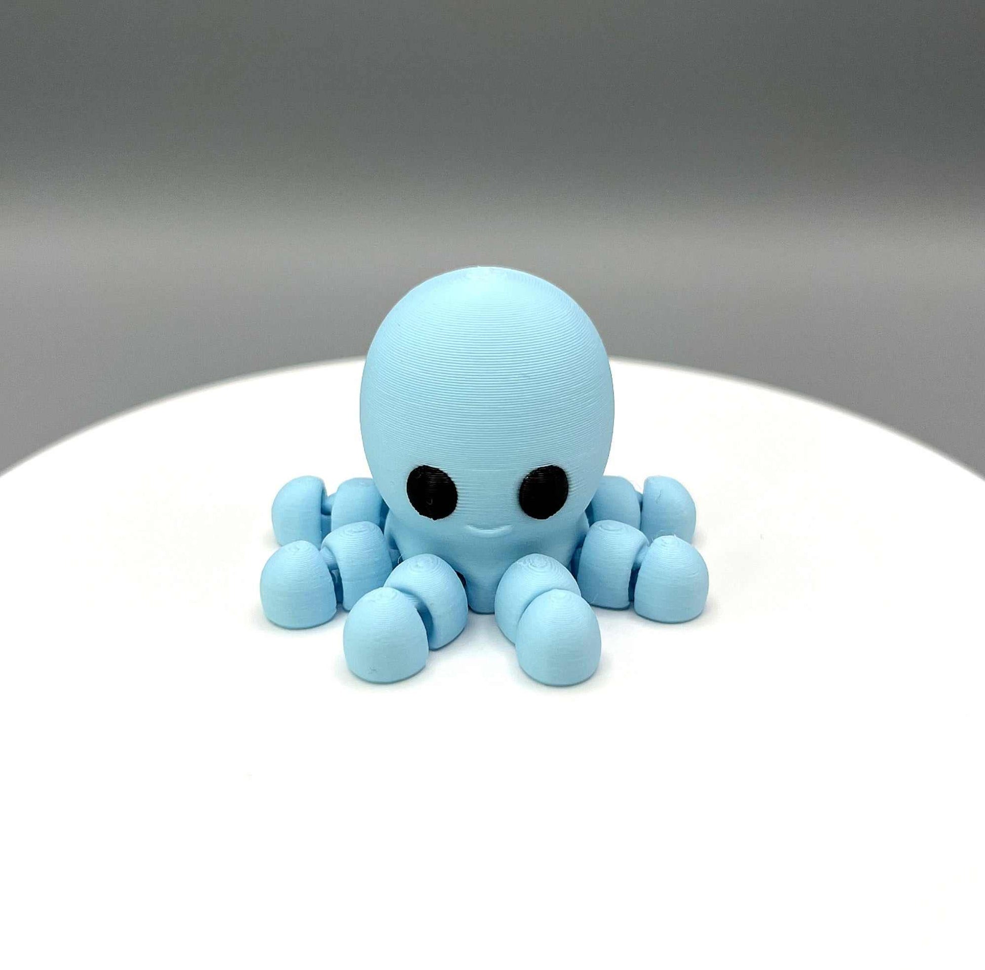 A 3D Printed Octopus Mini Figure with articulated legs and a cute face, perfectly pocket sized
