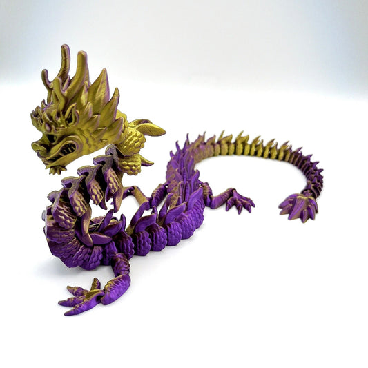 A 3D-printed figurine of a colourful Imperial Dragon with a detailed design, featuring a mix of gold and purple hues. Set against an off white background.
