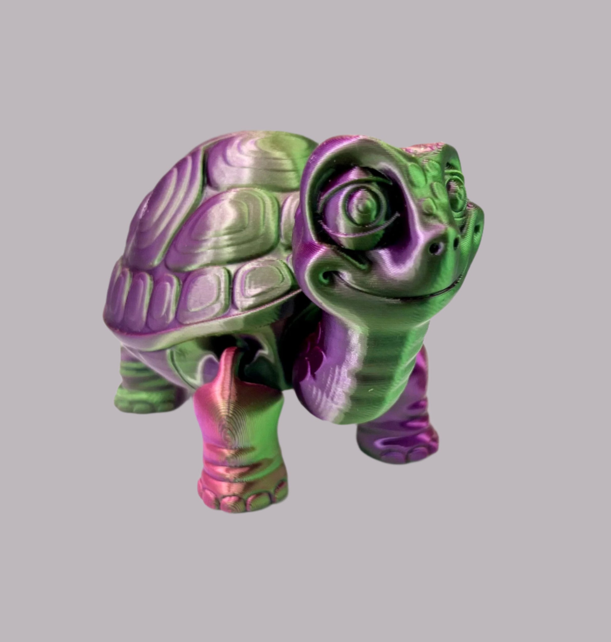 A cute 3D printed purple and green shiny tortoise with detailed face, shell and legs