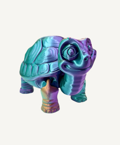 A cute 3D printed teal, purple and burnt orange shiny tortoise with detailed face, shell and legs