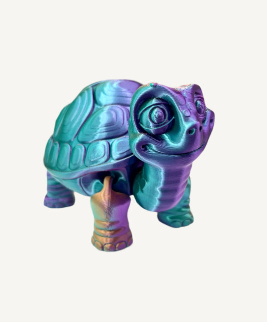 A cute 3D printed teal, purple and burnt orange shiny tortoise with detailed face, shell and legs
