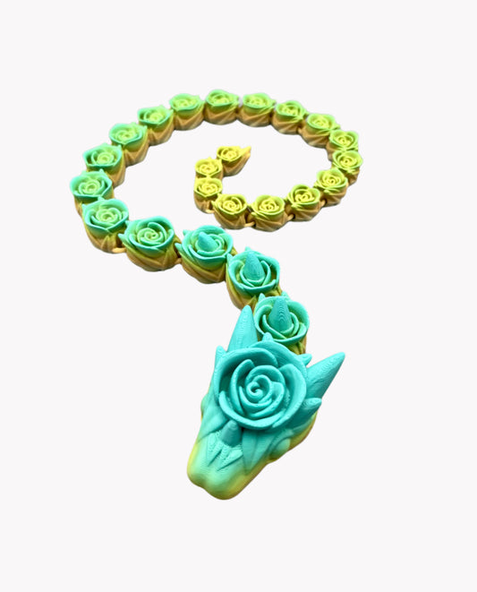 A 3D-printed snake with rose-like detailing all over from head to tail. Set on a pale grey background