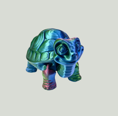 A cute 3D printed shiny blue, green and purple tortoise with detailed face, shell and legs