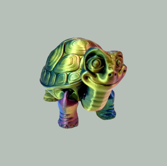 A cute 3D printed multi-coloured shiny tortoise with detailed face, shell and legs